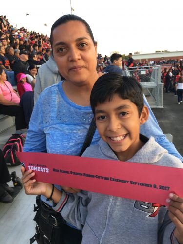 Alejandro Cervantes poses with his mother during the ribbon cutting ceremony at East High.
