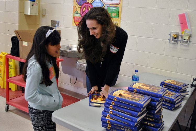 Author Kamilla Benko talks with a student about her new book.
