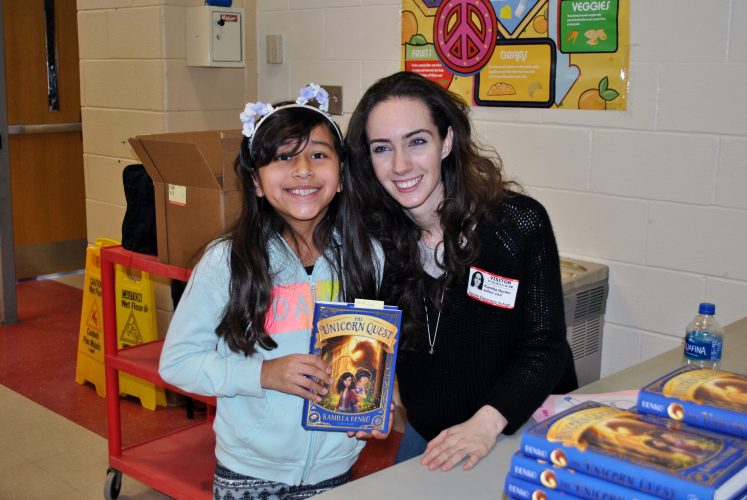 Author Kamilla Benko talks with a student about her new book.