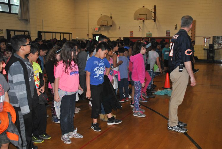 Mr. Dart, principal, dances with students to celebrate their success.