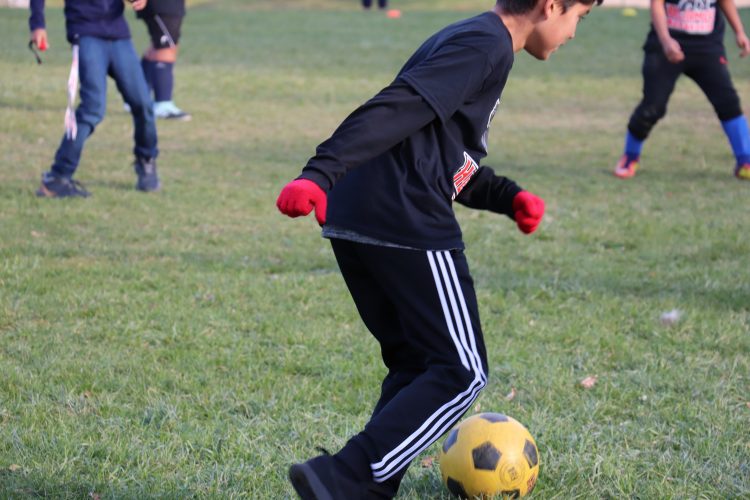 A student demonstrates his soccer skills.