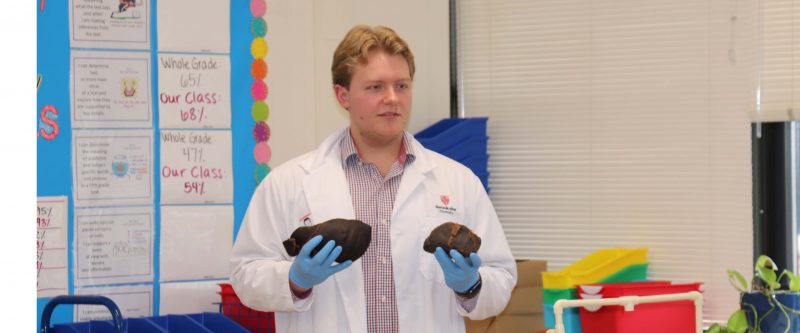 Future doctor, Noah Davis, shows students the difference between a healthy and non-healthy liver.