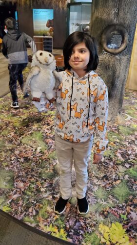 A student shows off some native Illinois species in puppet form.