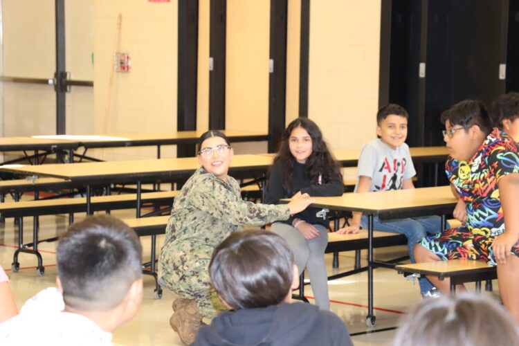 Ms. Guerrero talks with 5th grade students.