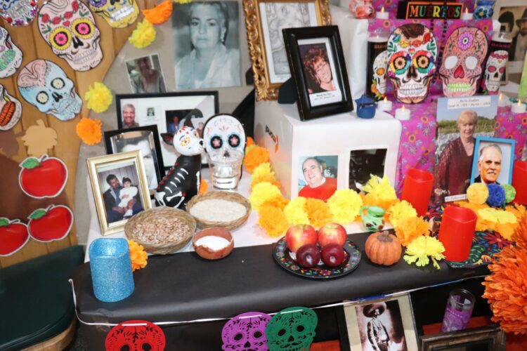 Photos and memories of loved ones adorn the Hermes ofrenda.