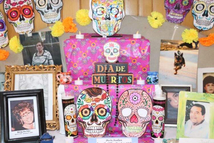 Photos and memories of loved ones adorn the Hermes ofrenda.