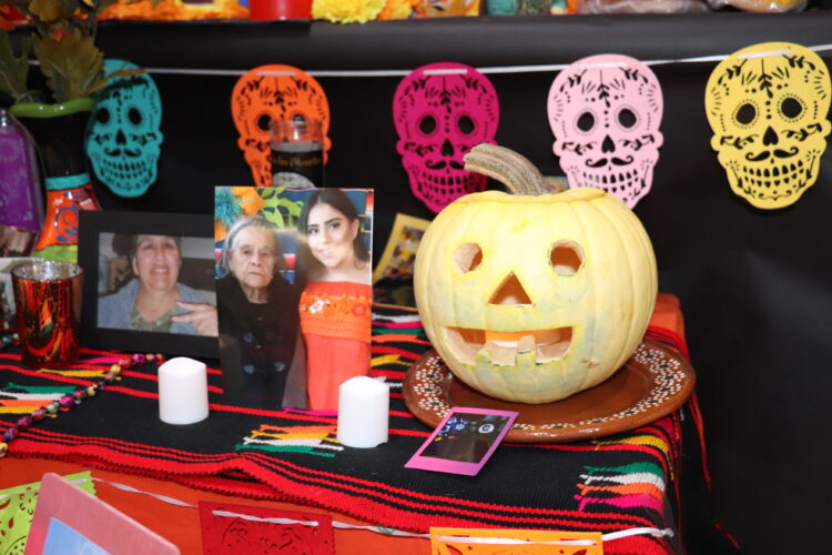 Photos and memories of loved ones adorn the Hermes ofrenda.