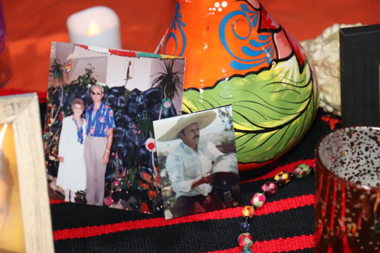 Photos and memories of loved ones adorn the Hermes ofrenda.