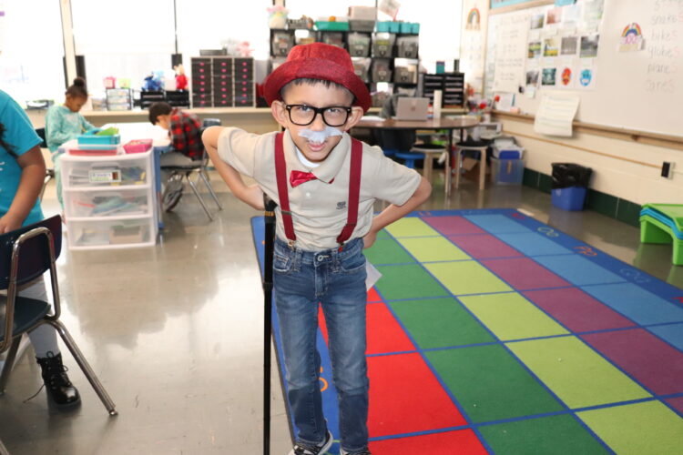 A "very old" first grader walks around his classroom.