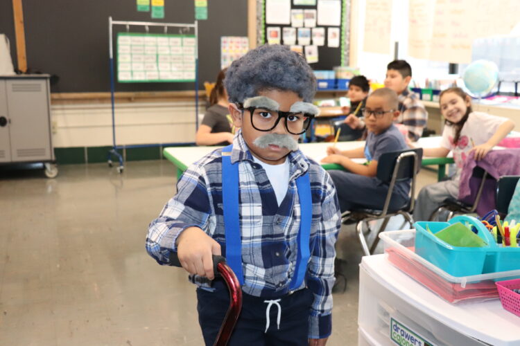 A "very old" first grader walks around his classroom.