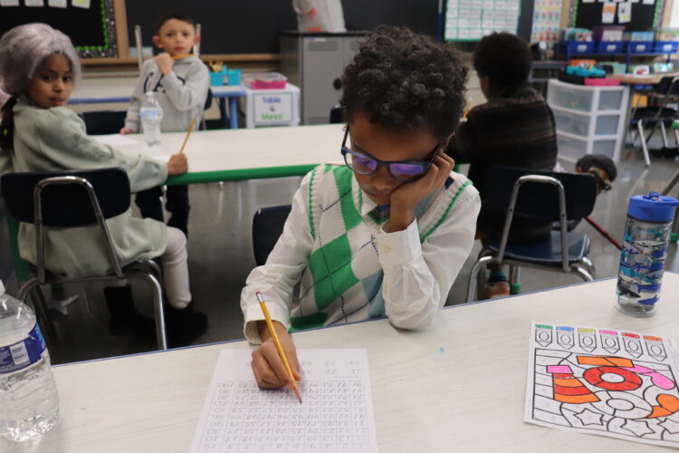 A "very old" first grader works on counting to 100.