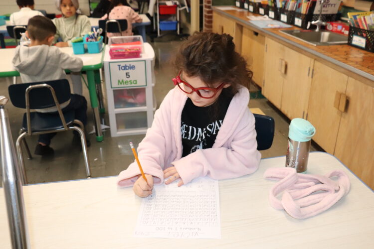 A "very old" first grader works on counting to 100.