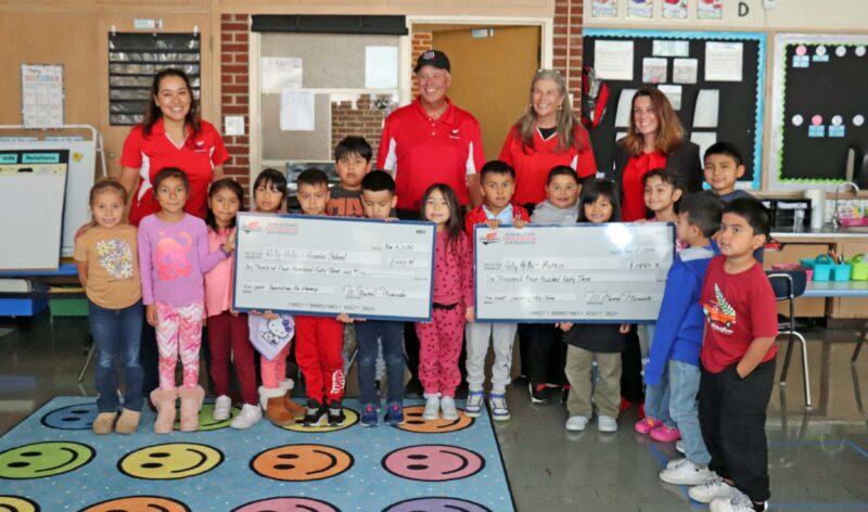 Principal, Mrs. Hills, celebrates winning a grant with 1st grade students.  Her grant will purchase decodable readers for Kindergarten and 1st grade students.
