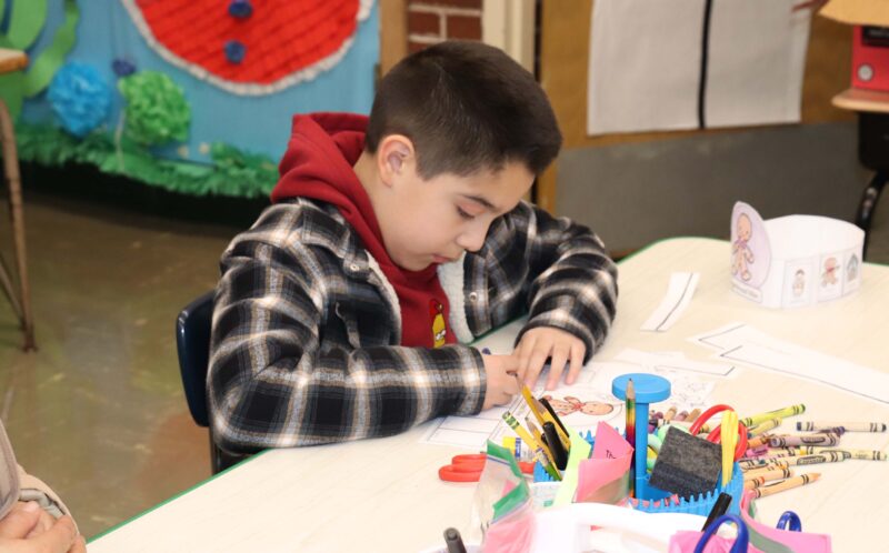 A student works on a gingerbread themed literacy activity.